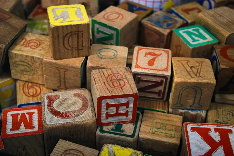Vintage wooden alphabet blocks in a pile